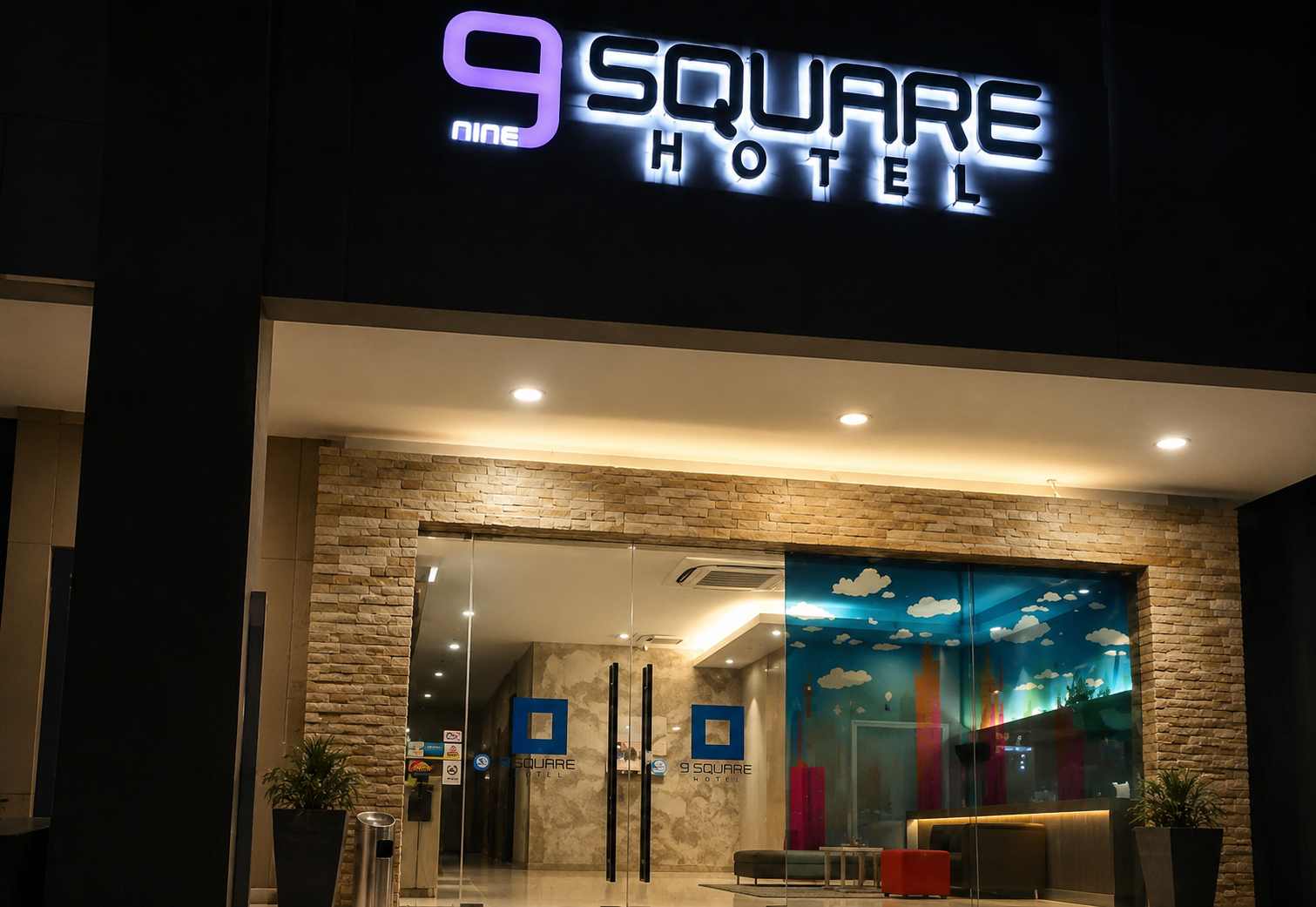 Illuminated 9 Square Hotel Subang signage above the hotel entrance at night